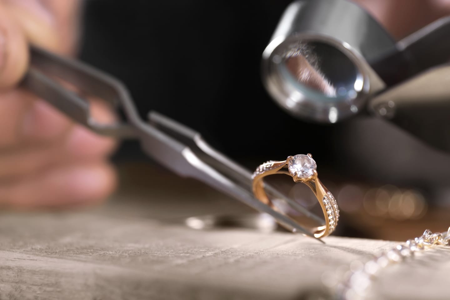 Master jeweler inspecting a custom diamond engagement ring